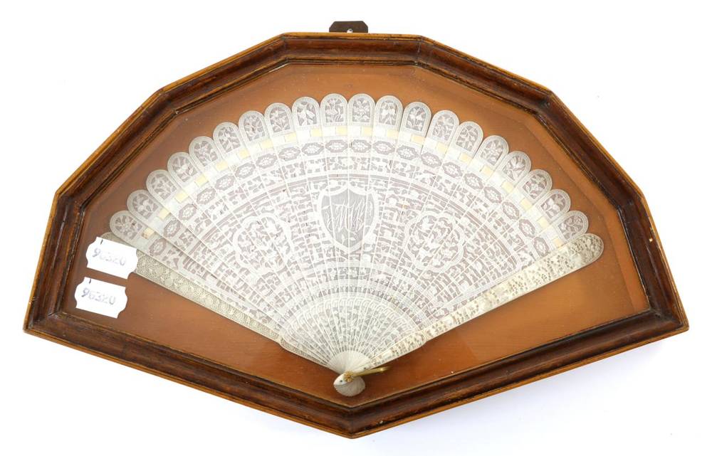 Lot 134 - A Chinese Carved Ivory Brisé Fan, circa 1840's, Qing Dynasty, contained in a shaped and glazed...