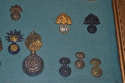 Lot 111 - A Collection of Twenty Headdress Badges to the Fusilier Regiments, in brass, bronze, gilt...