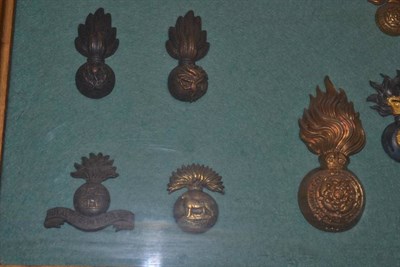 Lot 111 - A Collection of Twenty Headdress Badges to the Fusilier Regiments, in brass, bronze, gilt...