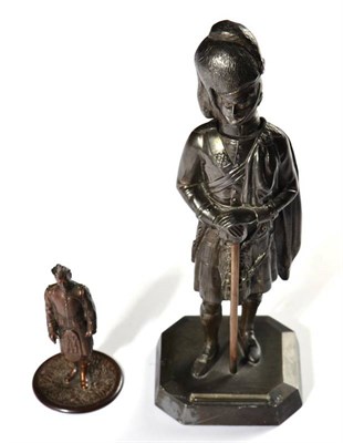 Lot 224 - A Bronzed Spelter Strike-a-Light as a Highlander, standing wearing a feather bonnet, plaid and...