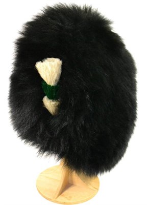 Lot 241 - An Elizabeth II OR's Ceremonial Bearskin Hat to the Welsh Guards, with white, green and white...