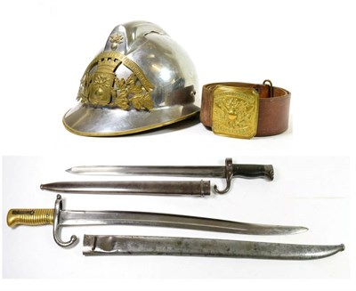 Lot 242 - A French Fireman's Adrian Helmet, with chromed finish and brass bound brim, the brass helmet...