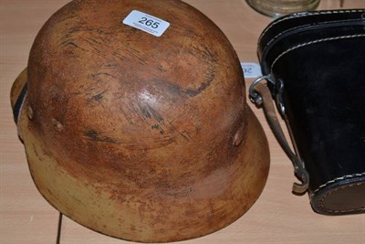 Lot 265 - A German Army M40 Combat Helmet, with later desert camouflage type paint, no decals, rolled...