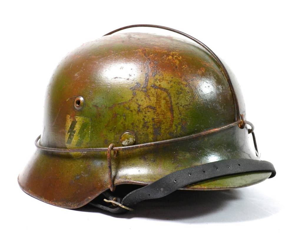 Lot 272 - A German Third Reich SS M35 Combat Helmet, with single decal, the original green paint now...