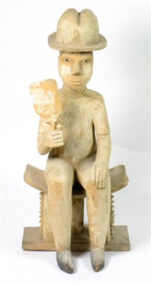 Lot 412 - An Ashante Akan Carved and Painted Wood Figure, Ghana, depicting a European-type man seated on...