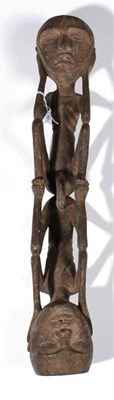 Lot 415 - An Indonesian Carved Wood Figure Group, as two conjoined reclining figures, each with bent arms and