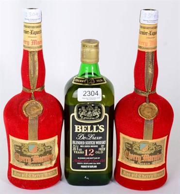 Lot 2304 - Cherry Marnier 430 proof 2 bottles and Bells De Luxe 12YO 70% 1 bottle