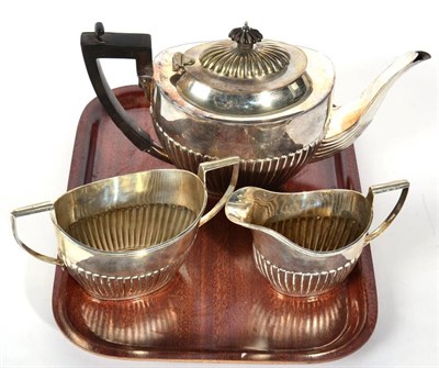 Lot 66 - A Canadian metalware three piece tea service, stamped Birks Sterling, part fluted oval form,...
