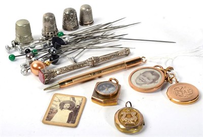 Lot 93 - A 9 carat gold propelling pencil; a Victorian locket stamped '15ct'; thimbles; hat pins etc