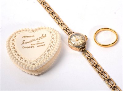 Lot 101 - A 22 carat gold band ring, finger size M1/2, 3.8g; and a 9 carat gold cased wristwatch, on a 9...