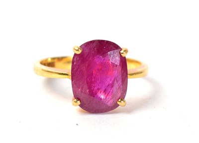 Lot 116 - A possibly synthetic ruby ring, an oval cut ruby in a claw setting, to knife edge shoulders, finger