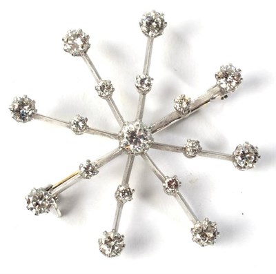 Lot 124 - A diamond snowflake brooch/pendant, a central round brilliant cut diamond in a claw setting to...