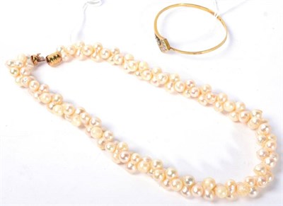 Lot 135 - A cultured pearl torsade necklace, with a barrel clasp and a diamond bangle, an arrow-motif...