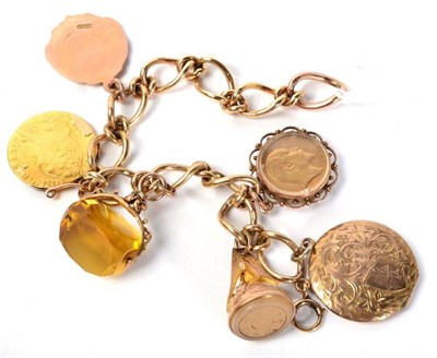 Lot 137 - A 9 carat gold charm bracelet, suspending an Edward VII 1909 half sovereign in glazed frame, a...