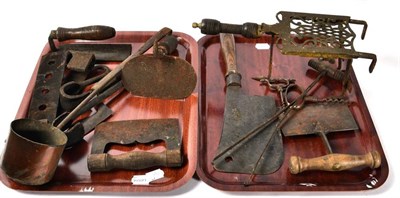 Lot 183 - A group of 19th century implements including herb cutters; meat cleaver; trivet etc (two trays)