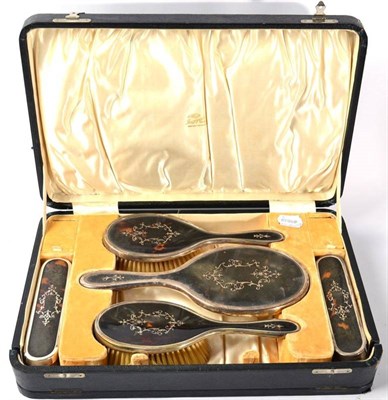 Lot 185 - A silver and tortoiseshell five piece dressing table set, London 1919, in a fitted case