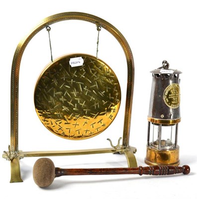 Lot 204 - A brass table gong and a miner's lamp with brass label marked ''Protector Lamp and Lighting Co Ltd