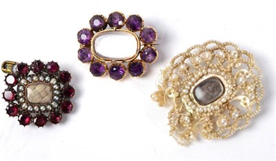 Lot 281 - A garnet and seed pearl mourning brooch, an amethyst mourning brooch and a seed pearl mourning...