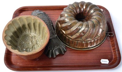 Lot 309 - A Victorian pottery jelly mould; a copper example; and a later fish form example