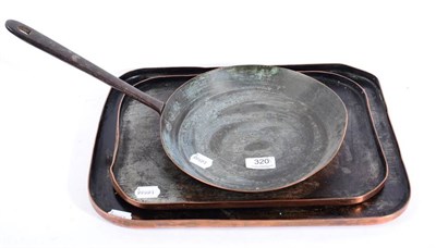 Lot 320 - A 19th century copper pan with wrought iron handle together with two rectangular copper trays
