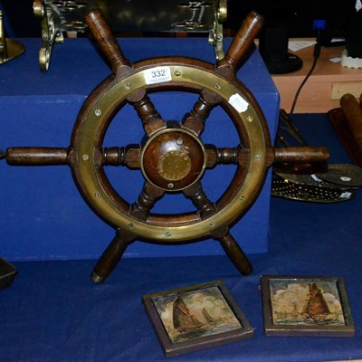 Lot 332 - A ship's wheel; and a pair of tiles with marine decoration (3)