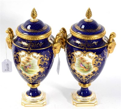 Lot 353 - A pair of Coalport twin handled vases and covers