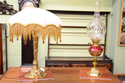 Lot 376 - A cast brass table lamp, with lily pad decorated foot; and a brass oil lamp (2)