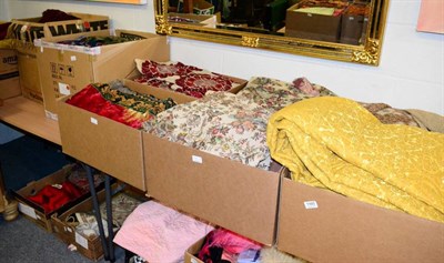 Lot 1165 - Assorted textiles in nine boxes including, chenille cloths, net curtains, woven and printed...