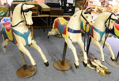 Lot 1171 - Three early 20th century wooden carousel horses (each with noticeable damage)
