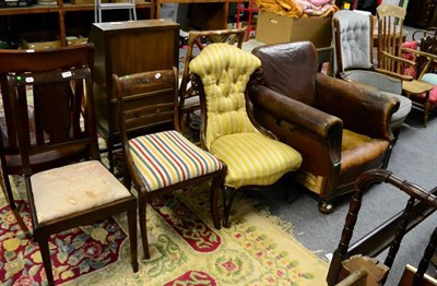 Lot 1184 - A quantity of various chairs comprising: a 1920's oak framed brown leather club chair, an oak...