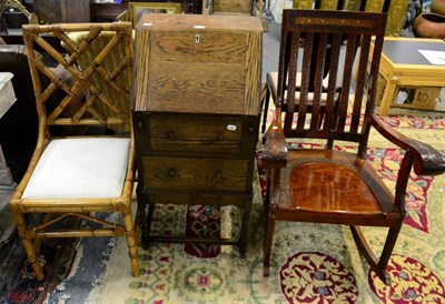 Lot 1185 - An oak bureau; a hardwood rocking chair; and a bamboo chair (3)