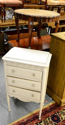 Lot 1199 - A marble topped white painted three height chest of drawers together with an occasional table...