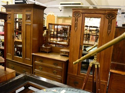 Lot 1212 - An early 20th century oak two piece bedroom suite comprising mirror fronted wardrobe and a dressing