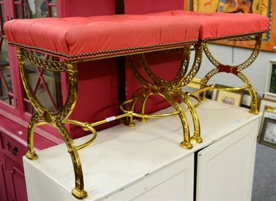 Lot 1228 - A pair of brass framed buttoned stools