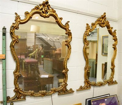 Lot 1237 - A pair of reproduction gilt framed wall mirrors in the Rococo taste