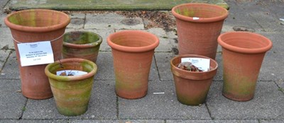 Lot 1249 - A single plank garden bench together with seven terracotta planters