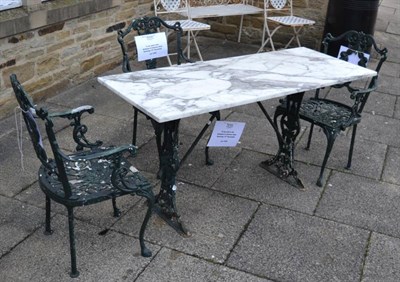 Lot 1252 - A marble topped cast iron garden table; a set of three painted metal chairs (4)