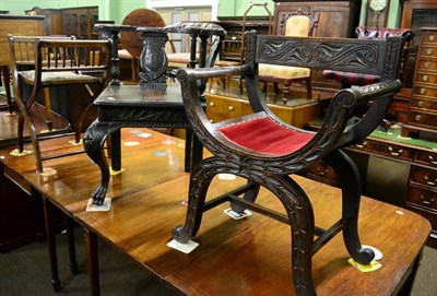 Lot 1304 - A Victorian carved oak corner chair; a carved oak armchair and a folding piano stool (3)