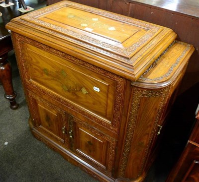 Lot 1312 - A carved and brass inlaid cocktail cabinet