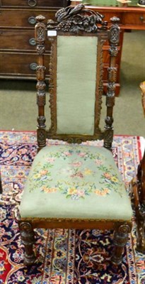 Lot 1323 - A Victorian carved mahogany nursing chair with woolwork floral upholstery