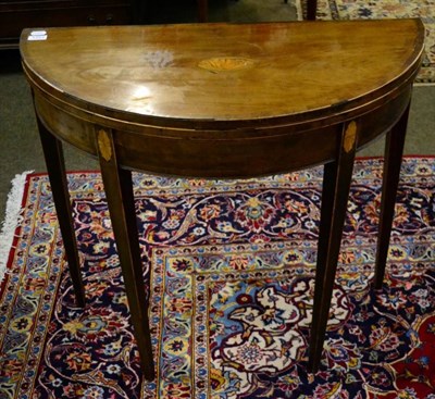 Lot 1357 - A George III mahogany inlaid foldover card table