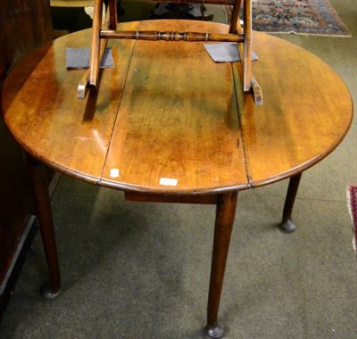 Lot 1377 - A 19th century mahogany circular drop leaf table on pad feet