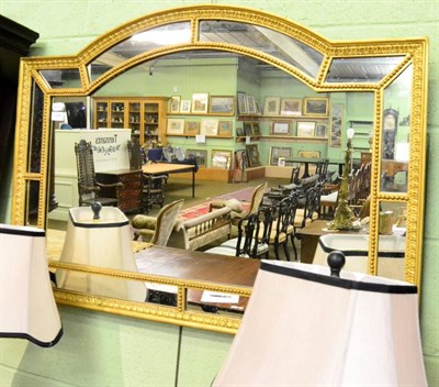 Lot 1395 - A 19th century gilt and gesso overmantel mirror, arched top with segmented border, moulded frame