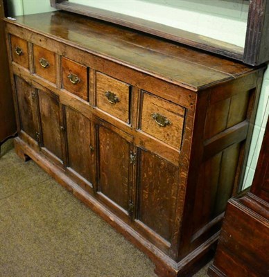 Lot 1398 - An 18th century oak sideboard comprising five drawers over two cupboard doors