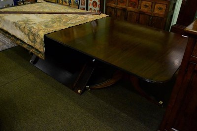 Lot 1403 - A George III style triple pedestal dining table with two extra leaves