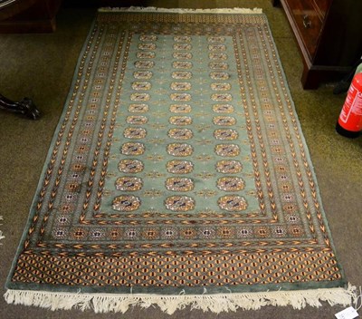 Lot 1415 - Lahore Bukhara rug, Pakistan, the apple green field with rows of guls enclosed by multiple borders