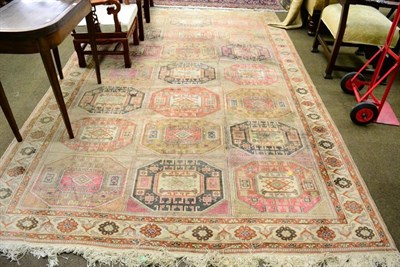 Lot 1416 - Anatolian carpet, the compartmentalised field of octagons enclosed by flower head borders, 350cm by