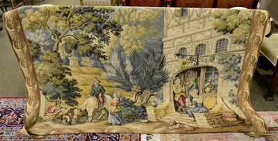 Lot 1417 - A machine made tapestry, 20th century, woven in wool depicting a rural inn enclosed by...