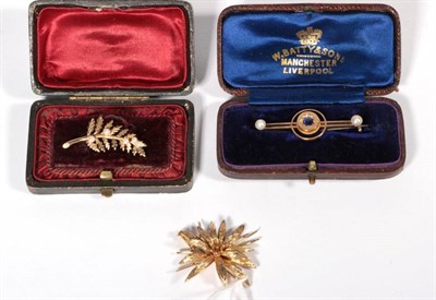 Lot 204 - A sapphire and pearl bar brooch, a star set round cut sapphire to a double bar terminating in...