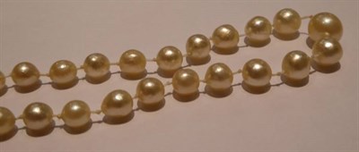 Lot 214 - An early 20th century graduated cultured pearl necklace, with a lozenge-shaped diamond set...